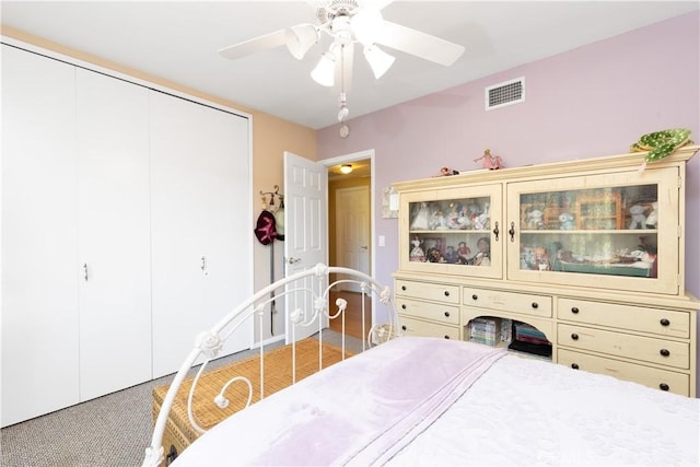 carpeted bedroom with ceiling fan and a closet