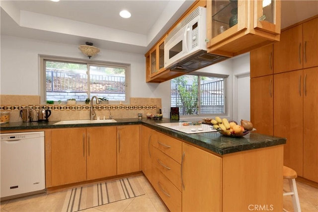 2541 Sleepy Hollow Dr, Glendale, CA 91206 - kitchen with white appliances, a peninsula, backsplash, a tray ceiling, and glass insert cabinets