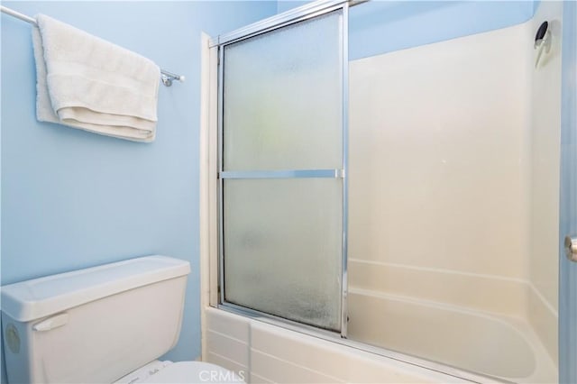 bathroom featuring toilet and enclosed tub / shower combo