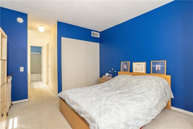 carpeted bedroom with a textured ceiling