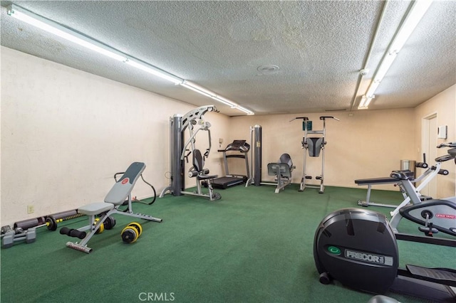 exercise room featuring a textured ceiling