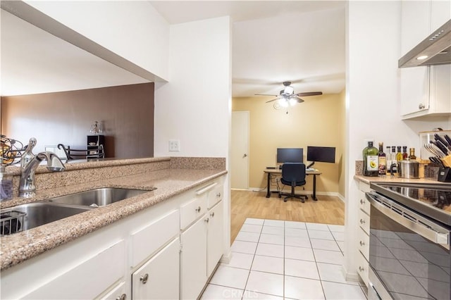 kitchen featuring sink, white cabinets, stainless steel electric range, and ventilation hood