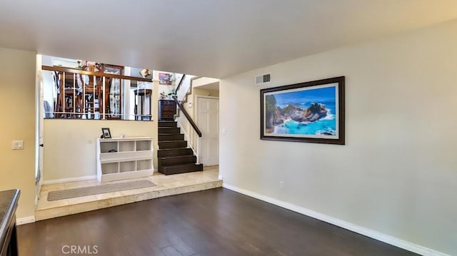 stairs featuring hardwood / wood-style floors