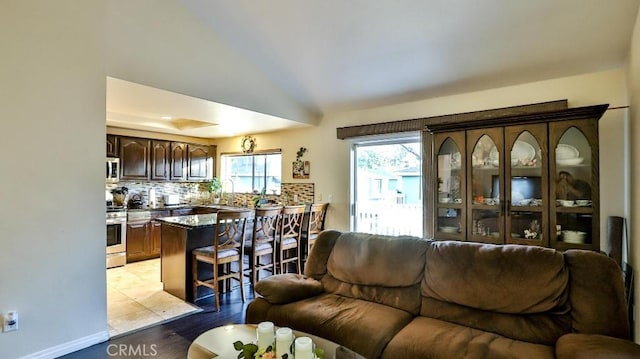 living room with light hardwood / wood-style flooring and sink