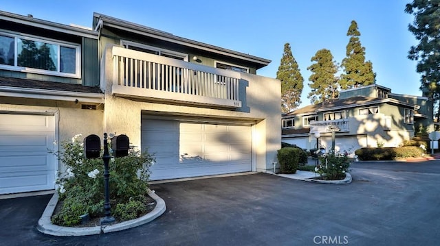 townhome / multi-family property featuring a garage and a balcony