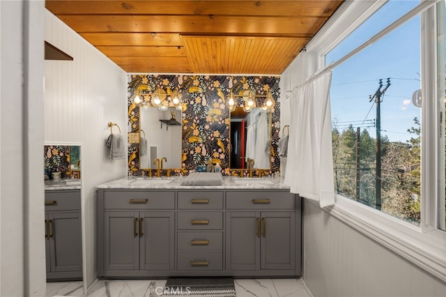 bathroom featuring vanity, wood walls, and wooden ceiling