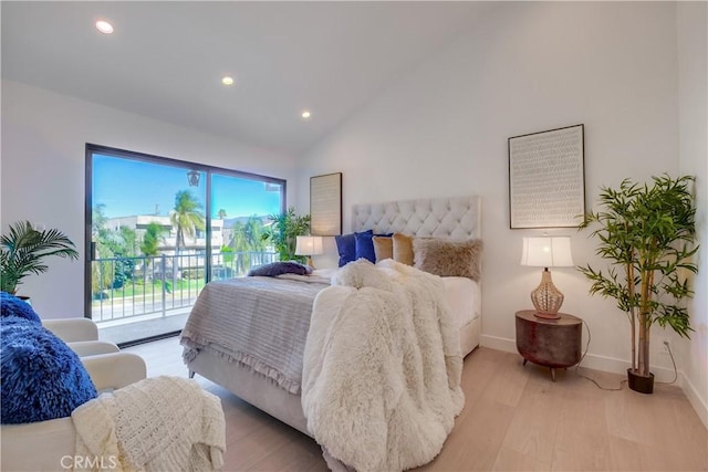 bedroom featuring access to exterior, light hardwood / wood-style flooring, and vaulted ceiling