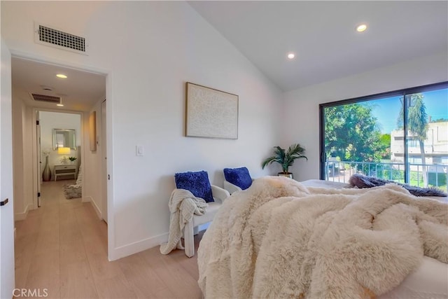 bedroom with light hardwood / wood-style floors and vaulted ceiling