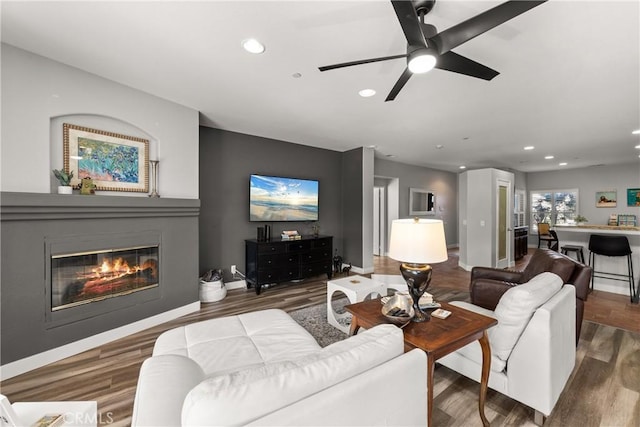 living room with hardwood / wood-style flooring and ceiling fan