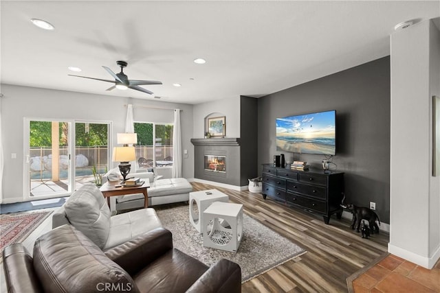 living room with hardwood / wood-style flooring and ceiling fan