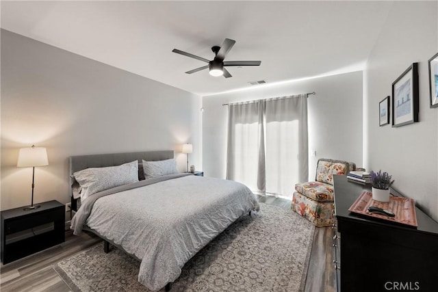 bedroom with ceiling fan and wood-type flooring