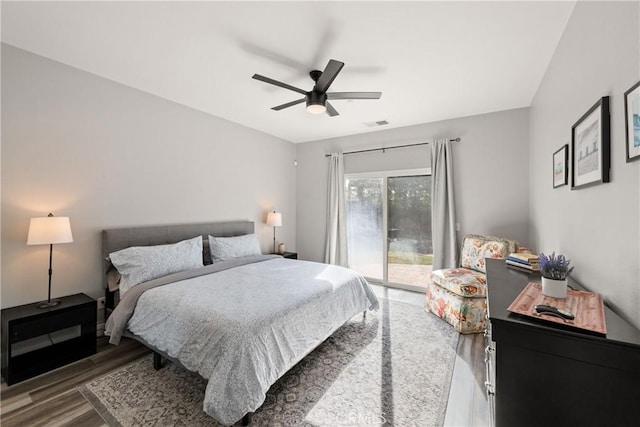 bedroom featuring hardwood / wood-style floors, access to outside, and ceiling fan