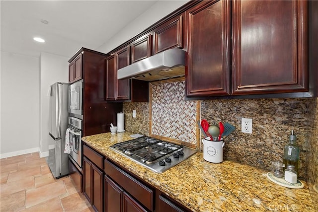 kitchen featuring decorative backsplash, light stone countertops, and appliances with stainless steel finishes