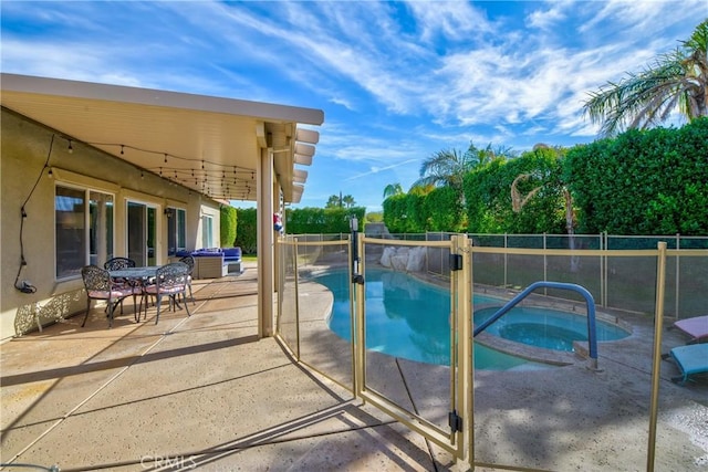 view of pool with an in ground hot tub and a patio area