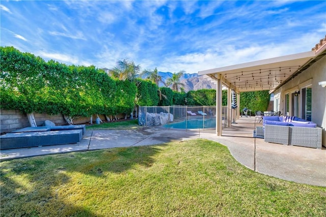 view of yard featuring a fenced in pool, a mountain view, outdoor lounge area, and a patio