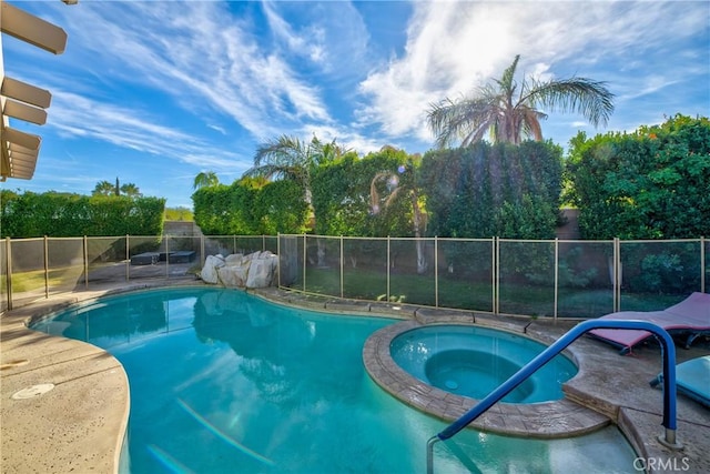 view of pool with an in ground hot tub