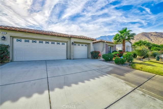 view of front of property featuring a mountain view and a garage