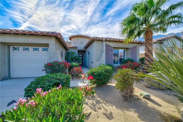 mediterranean / spanish-style home with a garage