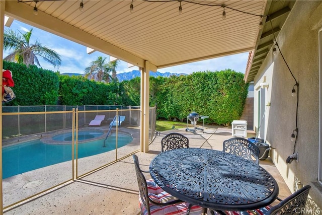 view of patio / terrace featuring a pool with hot tub