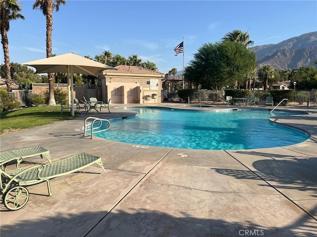 view of pool with a mountain view and a patio area