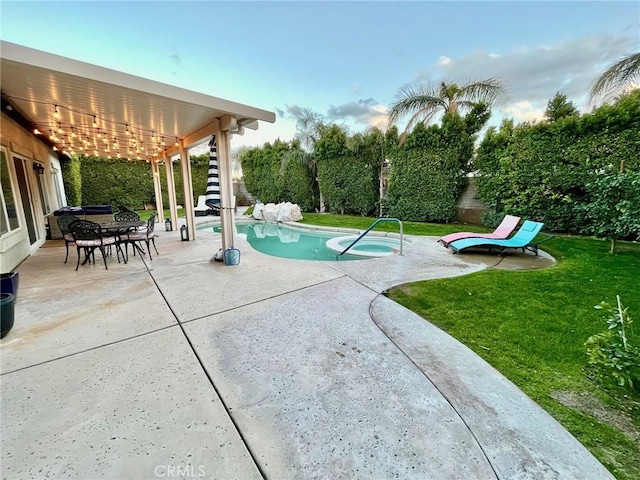 view of pool featuring a lawn and a patio area