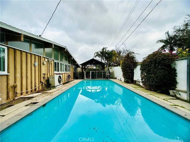 view of pool with ac unit and a gazebo