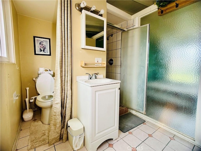 bathroom featuring toilet, vanity, tile patterned flooring, and a shower