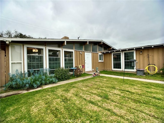 ranch-style house featuring a front lawn and central AC