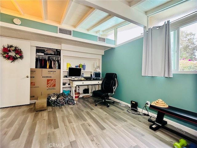 office space featuring vaulted ceiling and light hardwood / wood-style floors