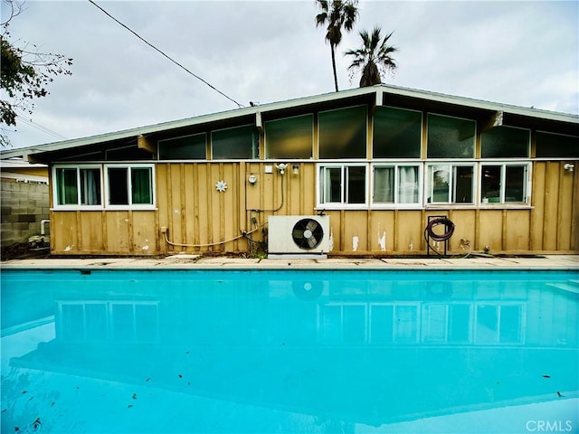 rear view of property with ac unit