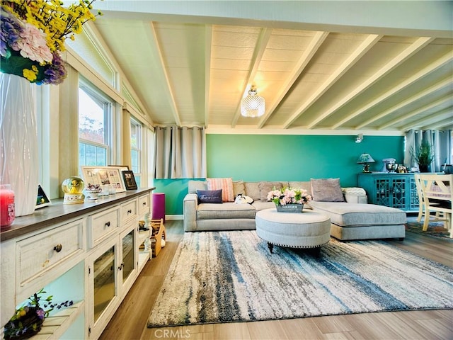 living area with hardwood / wood-style floors and beamed ceiling