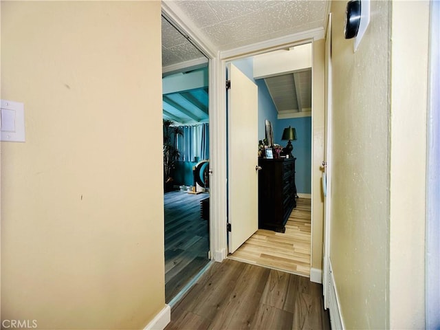 hallway featuring vaulted ceiling and light hardwood / wood-style floors