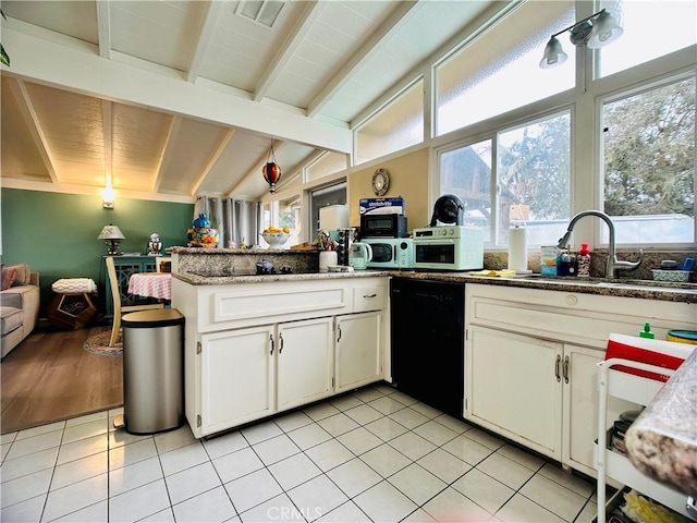 kitchen with white cabinetry, black dishwasher, kitchen peninsula, lofted ceiling with beams, and light tile patterned floors