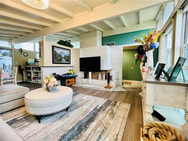 living room with hardwood / wood-style floors and beamed ceiling