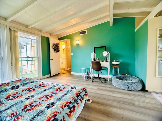 bedroom with vaulted ceiling with beams and wood-type flooring