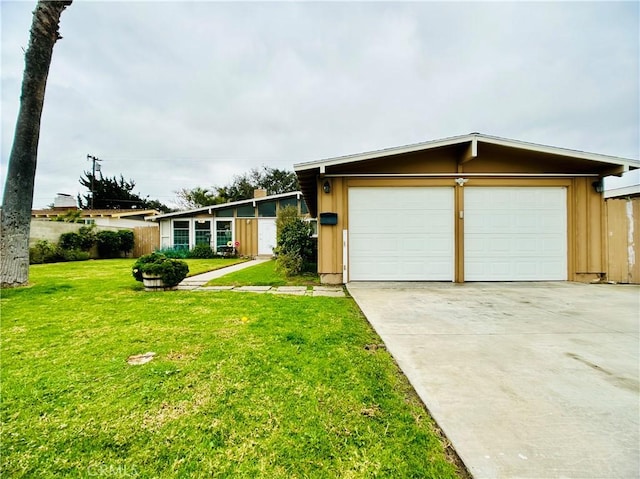 ranch-style house featuring a front lawn and a garage