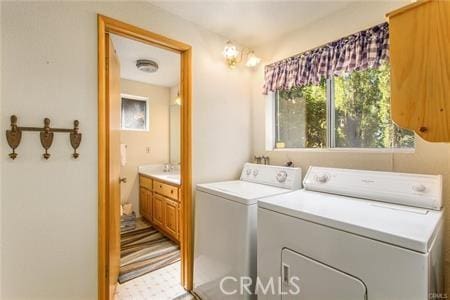 clothes washing area featuring separate washer and dryer