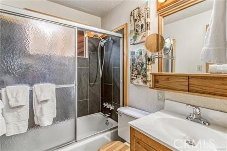 full bathroom with vanity, toilet, and shower / bath combination with glass door