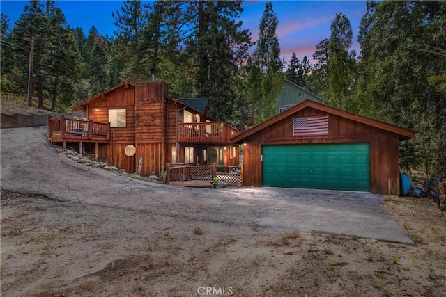 view of front of property with a garage and a wooden deck