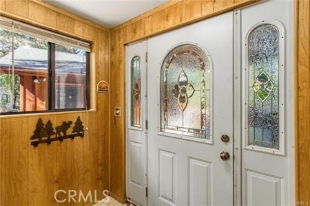 entryway featuring wood walls