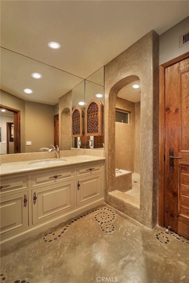 bathroom with vanity, visible vents, and recessed lighting