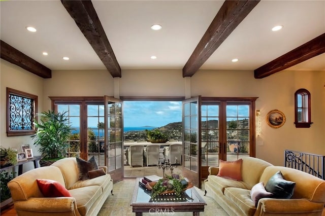 living area with recessed lighting, beam ceiling, and french doors