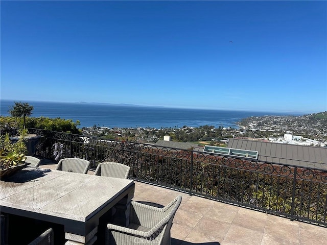 view of patio / terrace with a water view and outdoor dining space