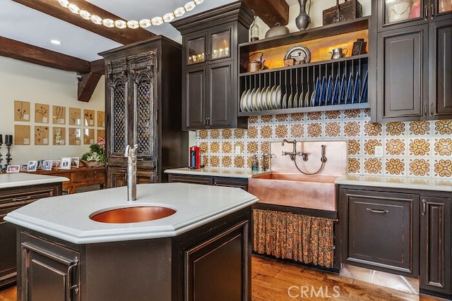 1330 Temple Hills Dr, Laguna Beach, CA 92651 - kitchen featuring a sink, beamed ceiling, light countertops, decorative backsplash, and open shelves