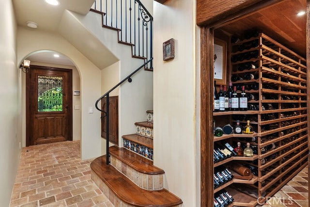 1330 Temple Hills Dr, Laguna Beach, CA 92651 - wine room featuring brick floors, arched walkways, and recessed lighting