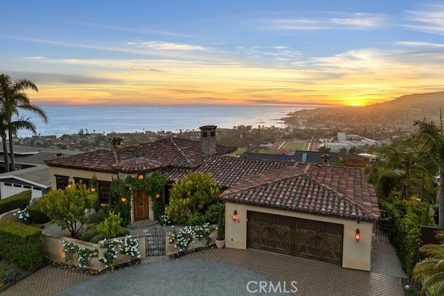 1330 Temple Hills Dr, Laguna Beach, CA 92651 - mediterranean / spanish home featuring a tiled roof, a garage, stucco siding, and driveway