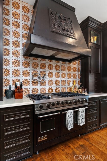 1330 Temple Hills Dr, Laguna Beach, CA 92651 - kitchen with range with two ovens, custom range hood, light countertops, glass insert cabinets, and dark wood finished floors