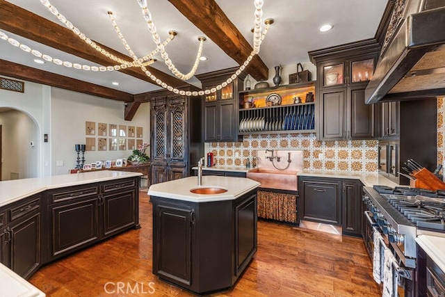 1330 Temple Hills Dr, Laguna Beach, CA 92651 - kitchen with exhaust hood, arched walkways, high end stainless steel range oven, light countertops, and decorative backsplash