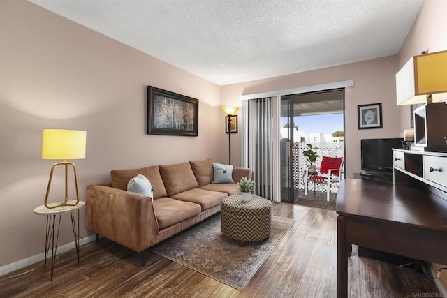 living room featuring dark hardwood / wood-style floors and a textured ceiling