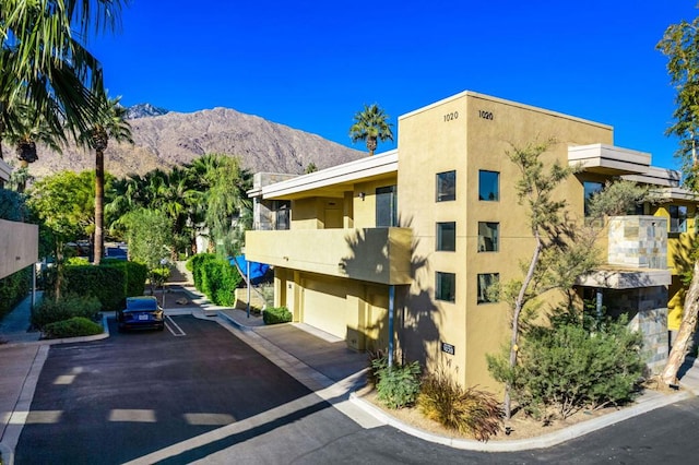 view of property featuring a mountain view and a garage